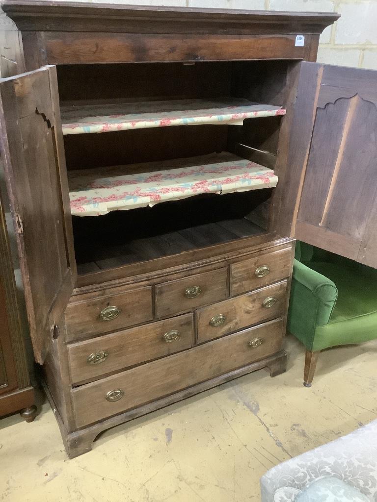 A mid 18th century oak two part bow fronted Dower chest / linen press, with doors enclosing shelves and six drawers, width 121cm